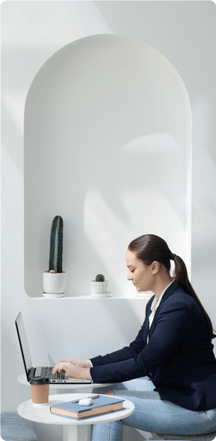 Woman working on laptop in business attire